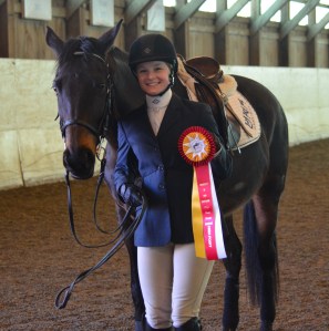 Sometimes Lee lets riders from other schools win prizes too-- here a rider from Colby Sawyer celebrates after winning reserve high point honors.