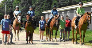 Participants in UNH's therapeutic riding program.  Shazaam, Marcy and Quill are all now retired, while Snowy (second from right) is a boarder who still works part time in the therapeutic program.